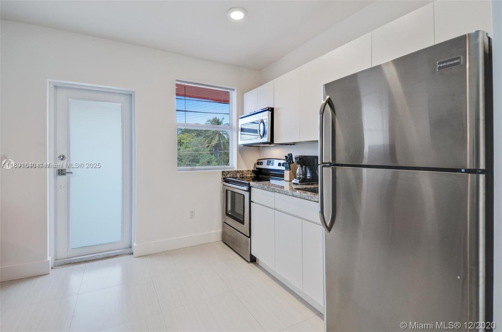 2601 Northwest 1st Avenue, Unit 6 Miami, FL 33127 - Photo 10 of 11 a kitchen with stainless steel appliances granite countertop a refrigerator and a sink