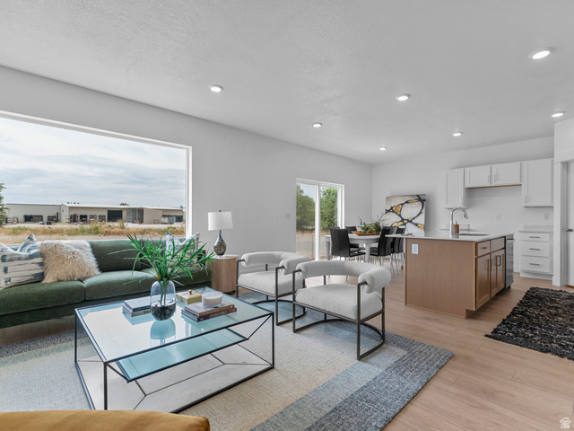 738 West 2840 South, Unit 6 Nibley, UT 84321 - Photo 9 of 23 Open-concept interior featuring light wood-finish flooring, recessed lighting, and a prominent window