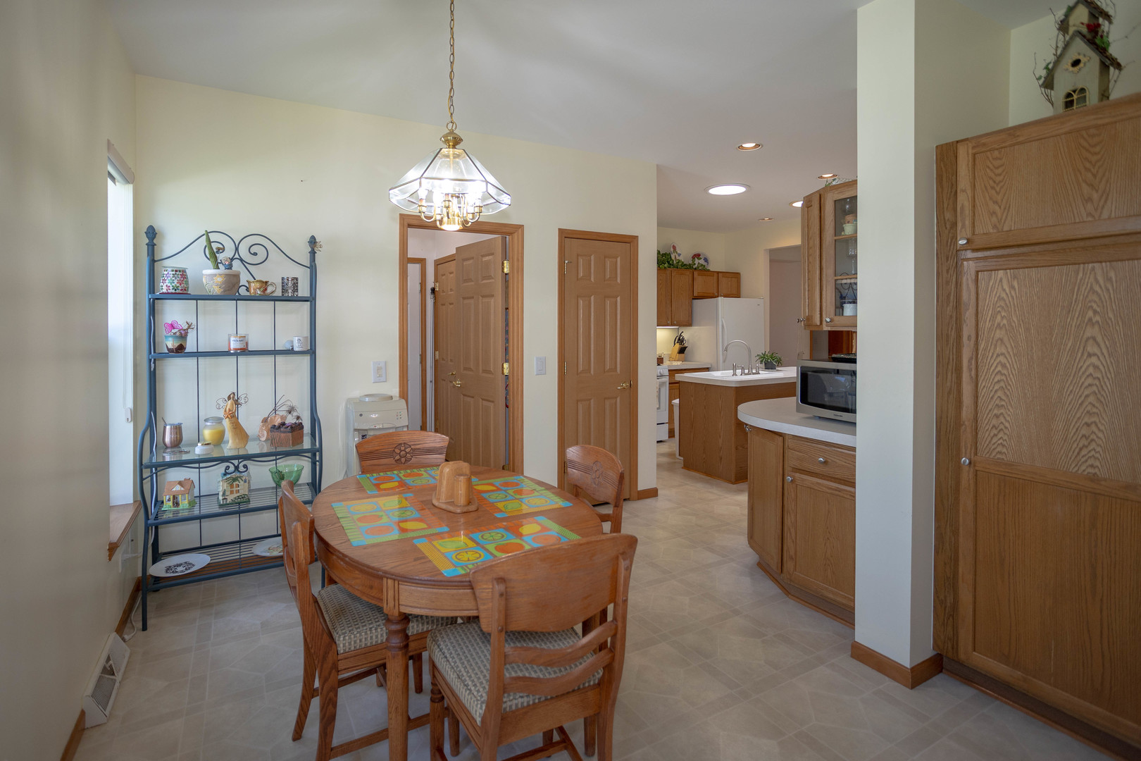 212 Rodeo Drive, Unit 2179 Grayslake, IL 60030 - Photo 12 of 31 a kitchen with stainless steel appliances a dining table chairs and refrigerator