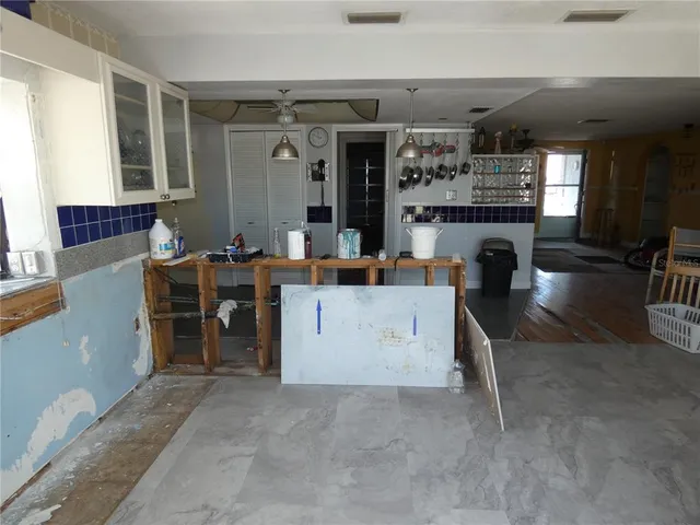 a view of a kitchen with furniture and refrigerator