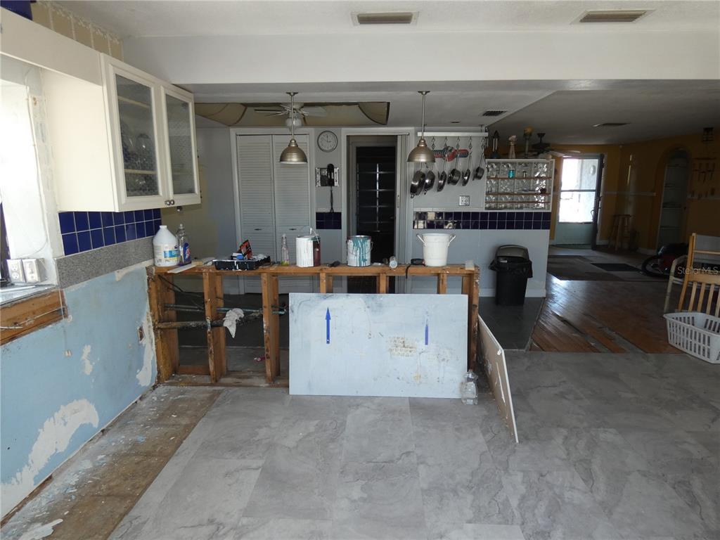 13618 Stacey Drive Hudson, FL 34667 - Photo 17 of 34 a view of a kitchen with furniture and refrigerator