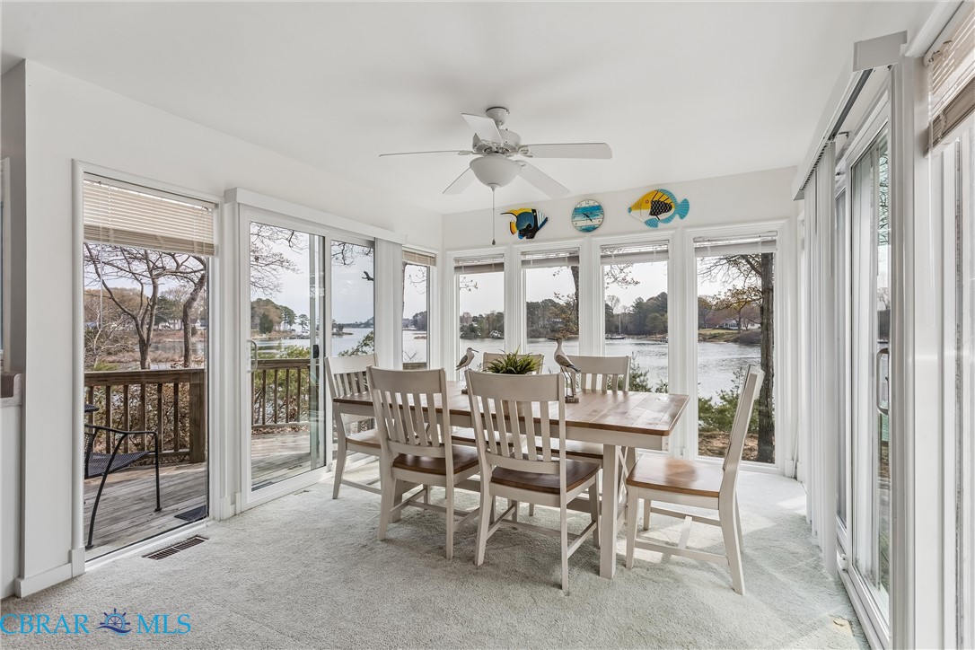 172 Sturgeon Creek Road Deltaville, VA 23043 - Photo 9 of 50 Sunroom / solarium with a water view and carpet