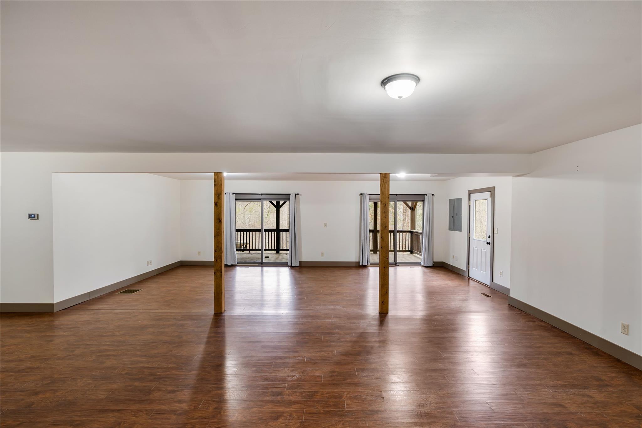 23 Ruffed Grouse Drive Weaverville, NC 28787 - Photo 32 of 48 an empty room with wooden floor and windows