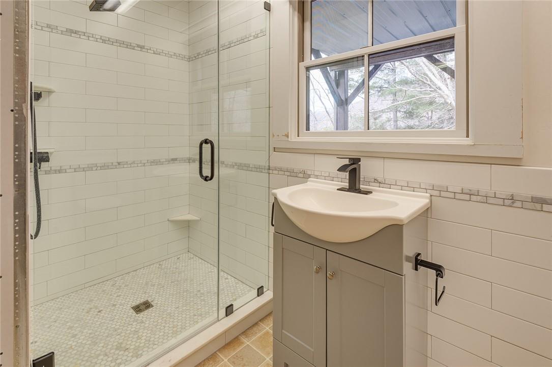 23 Ruffed Grouse Drive Weaverville, NC 28787 - Photo 36 of 48 a bathroom with a sink a mirror and a shower