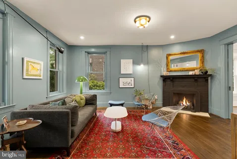 a view of a dining room with furniture and a book shelf