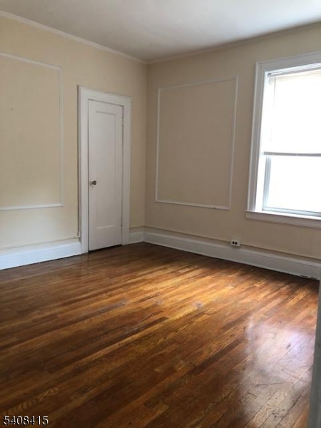 16 Seymour Street, Unit 21 Montclair, NJ 07042 - Photo 4 of 6 an empty room with wooden floor and windows