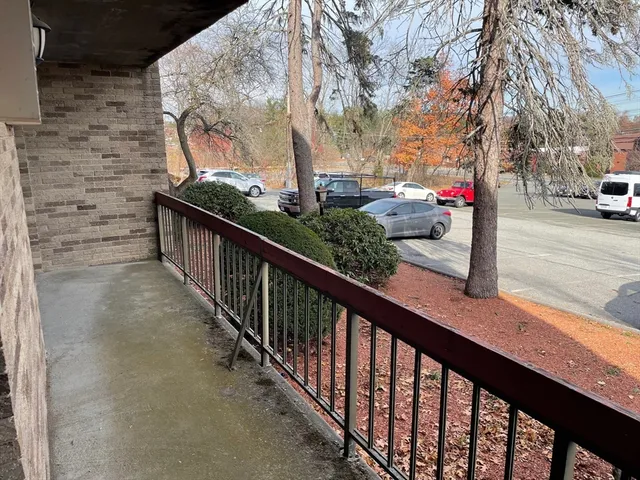 a view of a balcony with two trees