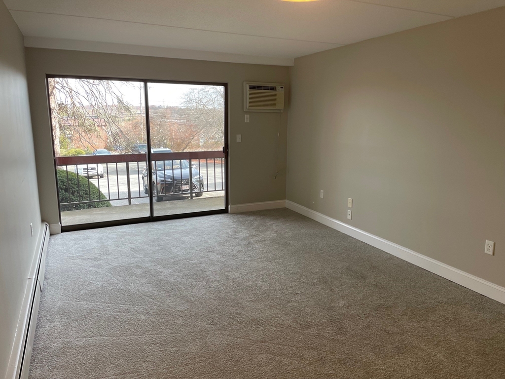 59 Cambridge Road, Unit 108 Woburn, MA 01801 - Photo 3 of 11 a view of an empty room with a window