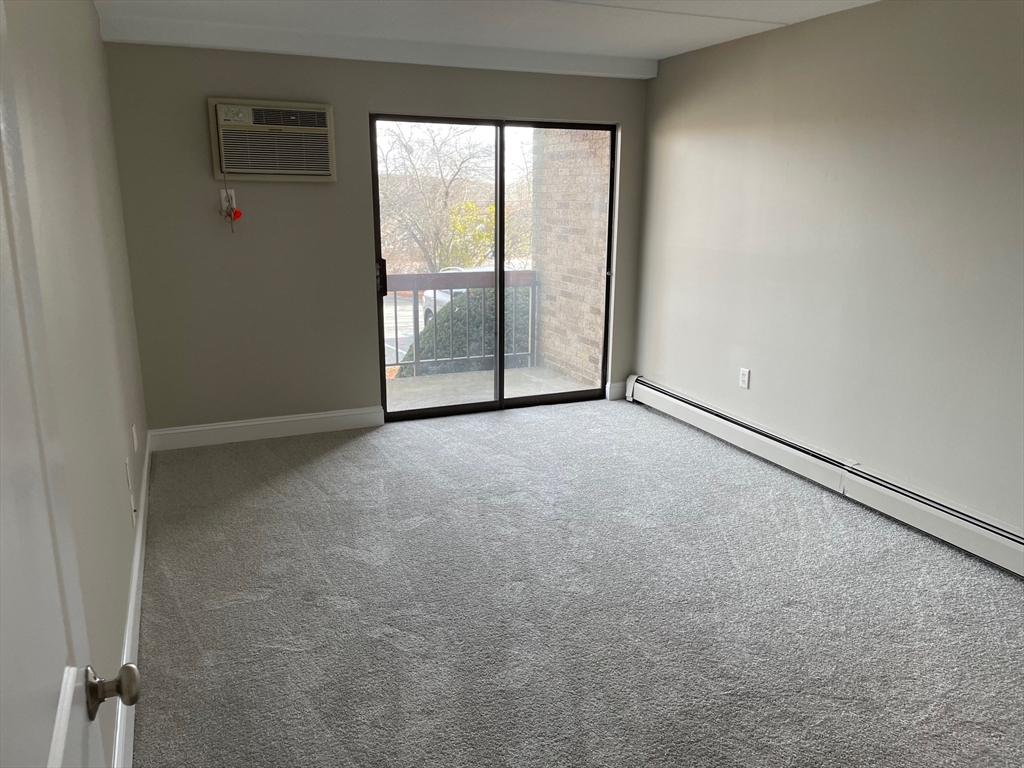 59 Cambridge Road, Unit 108 Woburn, MA 01801 - Photo 8 of 11 an empty room with windows