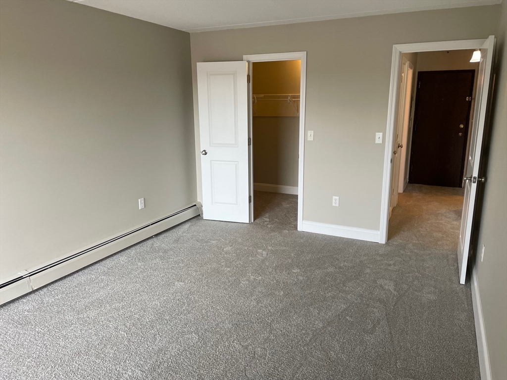 59 Cambridge Road, Unit 108 Woburn, MA 01801 - Photo 9 of 11 an empty room with closet area