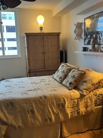 a bedroom with a bed and a night stand