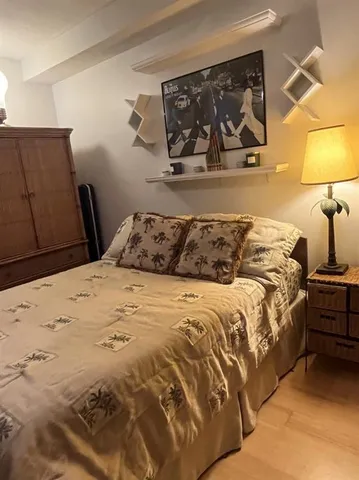 a bedroom with a bed and a television