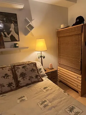 a bedroom with a bed and a dresser