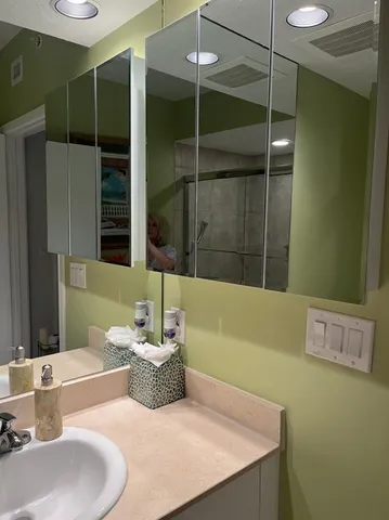 a bathroom with a shower a toilet and a sink