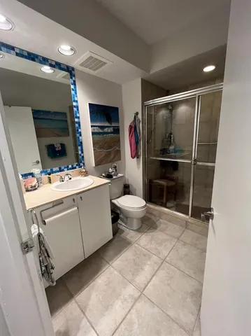 a kitchen with stainless steel appliances granite countertop a refrigerator a stove and a sink