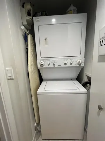 a room with gym equipment and kitchen view