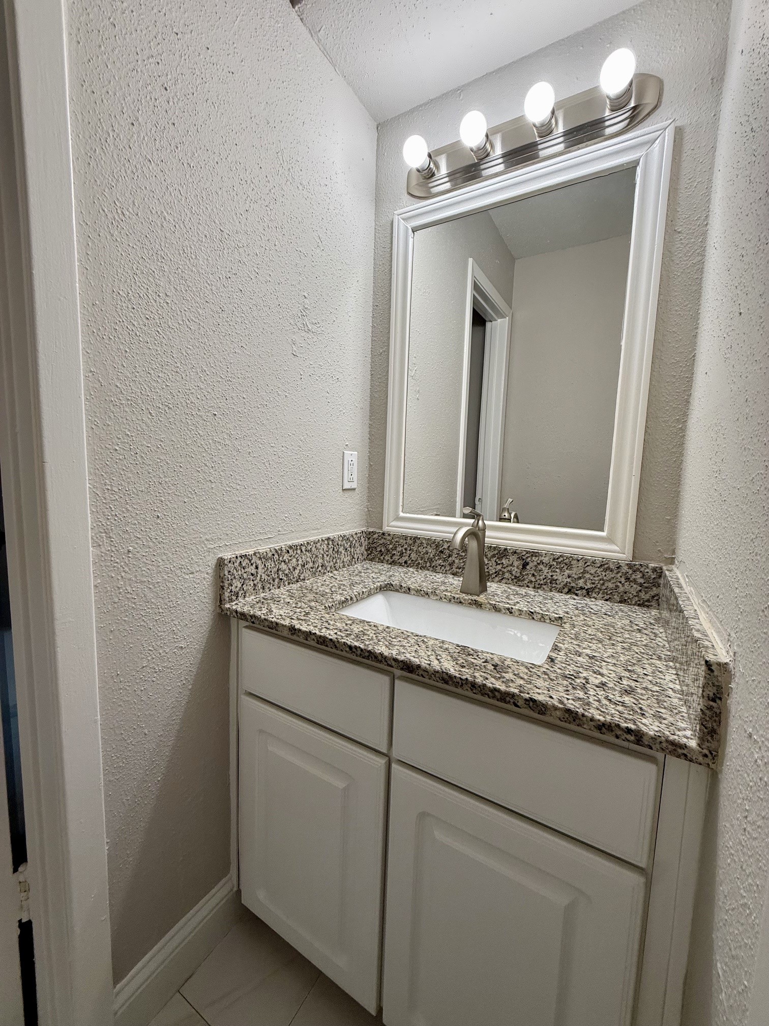 1518 Wirt Road, Unit 6 Houston, TX 77055 - Photo 10 of 14 a bathroom with a granite countertop sink and a mirror