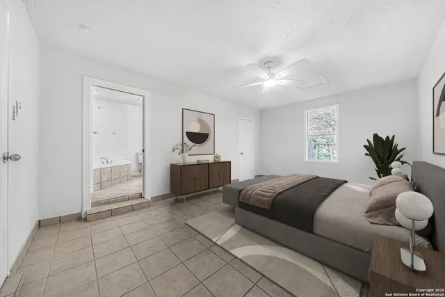 a spacious bedroom with a bed and window