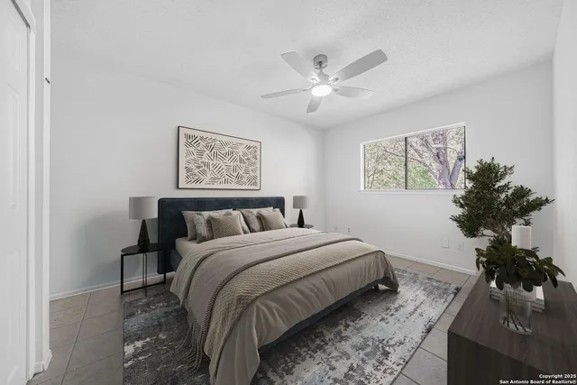 a bedroom with a large bed and a chandelier
