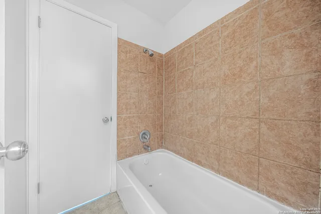 a bathroom with a bathtub and shower