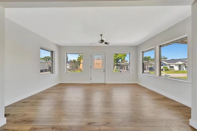 wooden floor in an empty room with a window