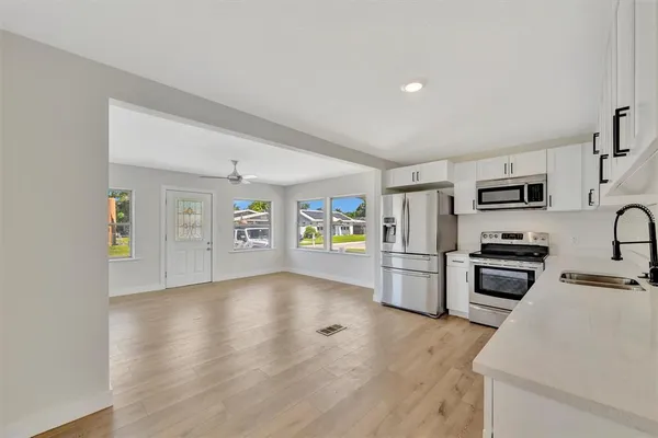 a kitchen with stainless steel appliances a stove cabinets and a refrigerator