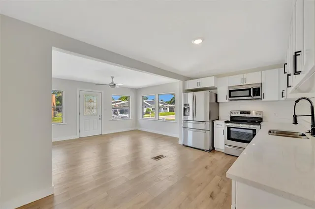 a kitchen with stainless steel appliances a stove cabinets and a refrigerator