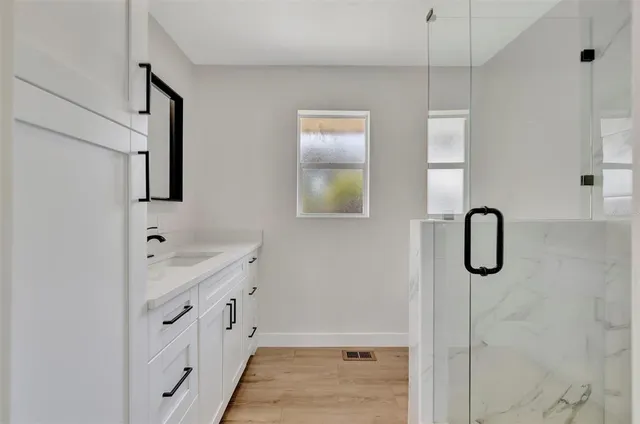 a bathroom with a bathtub and a shower
