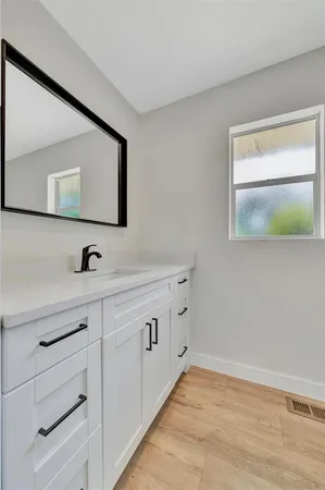 a bathroom with a double vanity sink and mirror