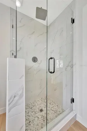 a bathroom with a glass shower door
