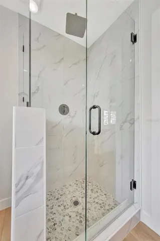 a bathroom with a glass shower door