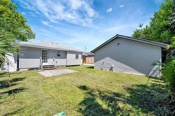 a house view with swimming pool in front of it