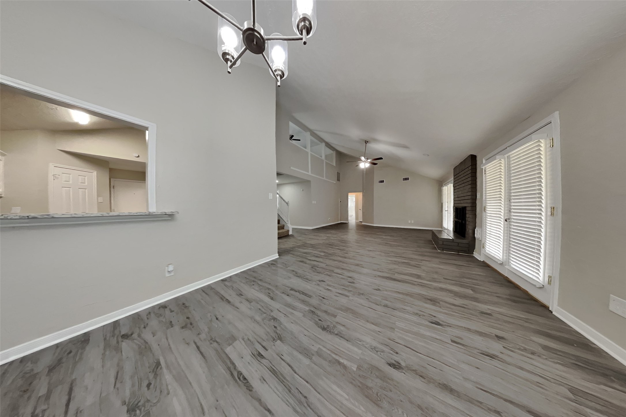 6818 White Tail Drive Spring, TX 77379 - Photo 11 of 24 a view of an empty room with wooden floor and a ceiling fan