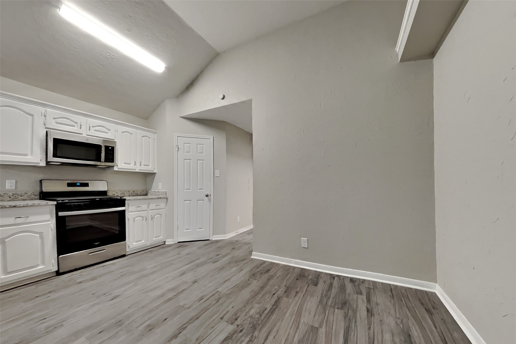 6818 White Tail Drive Spring, TX 77379 - Photo 9 of 24 a view of a kitchen with wooden floor and electronic appliances