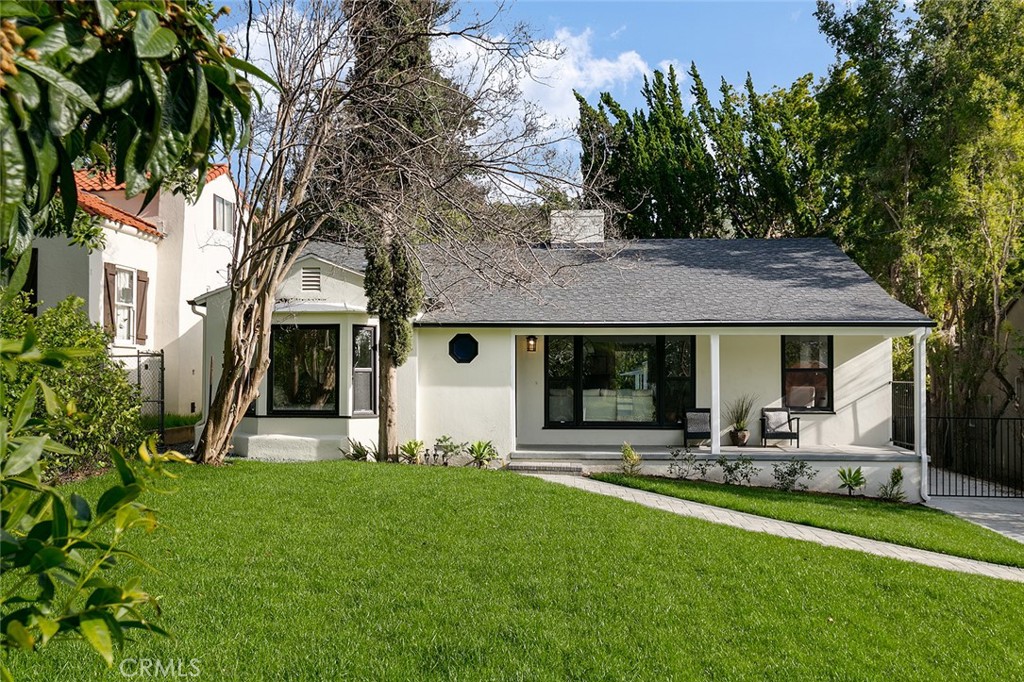 a view of a house with backyard porch and sitting area