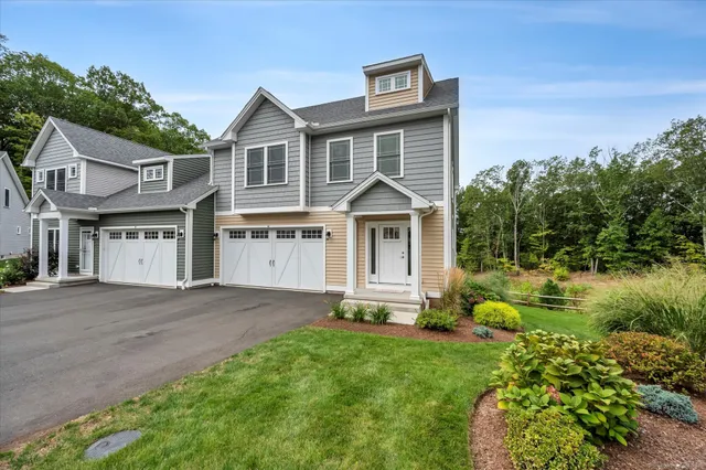 a front view of a house with a garden and plants