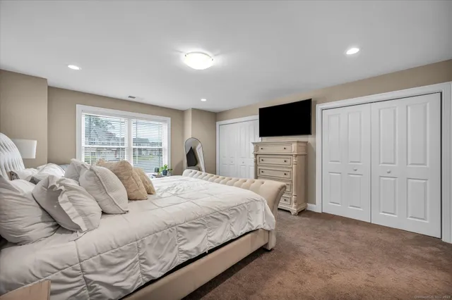 a bedroom with a bed and a television