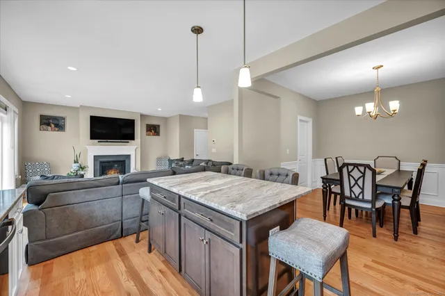 a kitchen with a table chairs sink and wooden floor
