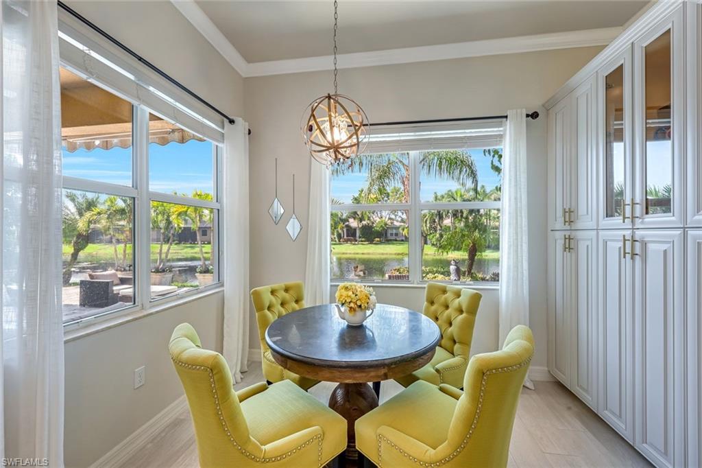 6582 Monterey Point Naples, FL 34105 - Photo 11 of 28 a view of a dining room with furniture a chandelier and wooden floor