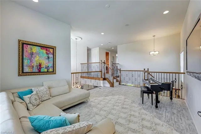 a living room with furniture and a piano