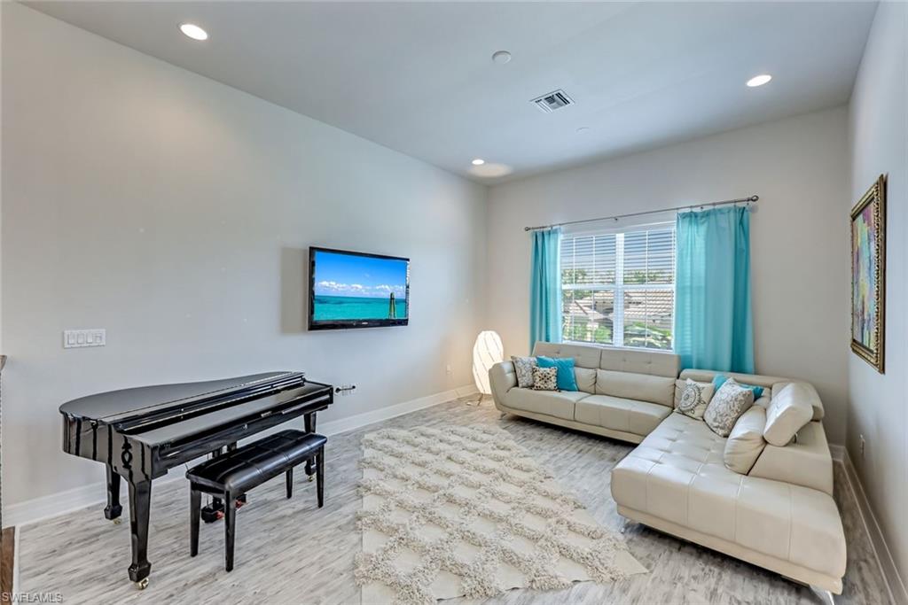 6582 Monterey Point Naples, FL 34105 - Photo 13 of 28 a living room with furniture and a piano