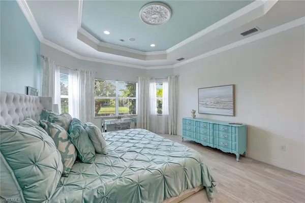 a bedroom with a bed and a chandelier