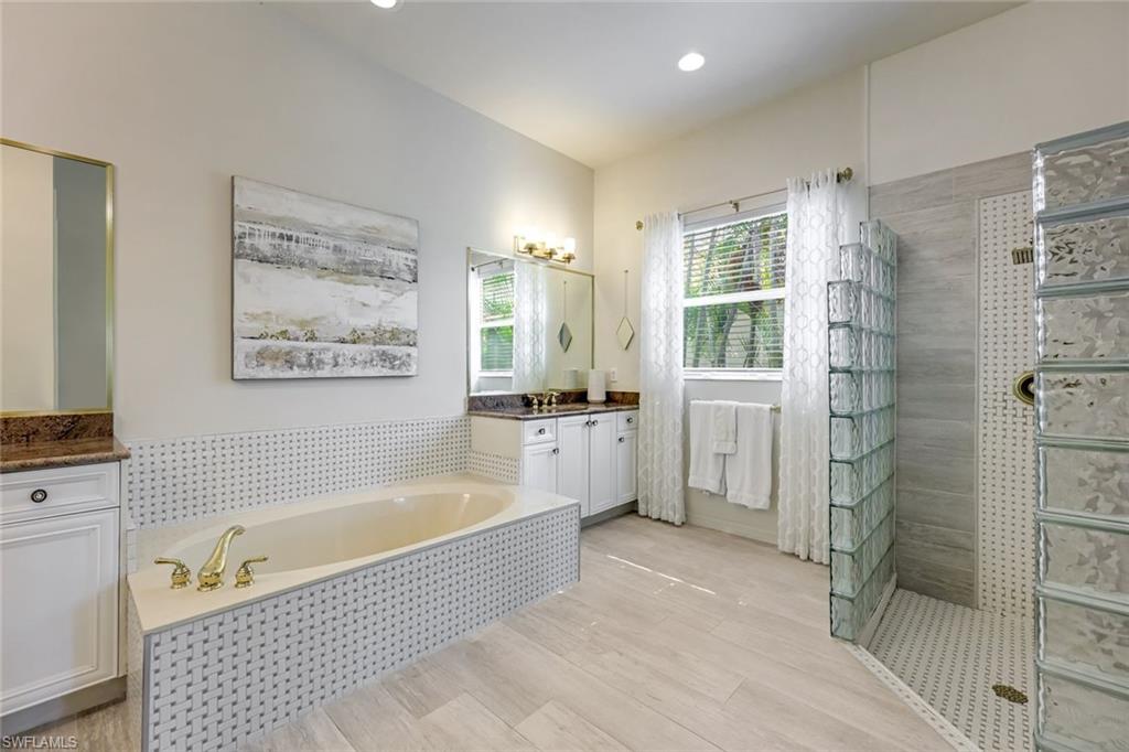 6582 Monterey Point Naples, FL 34105 - Photo 16 of 28 a bathroom with a bathtub shower and a sink