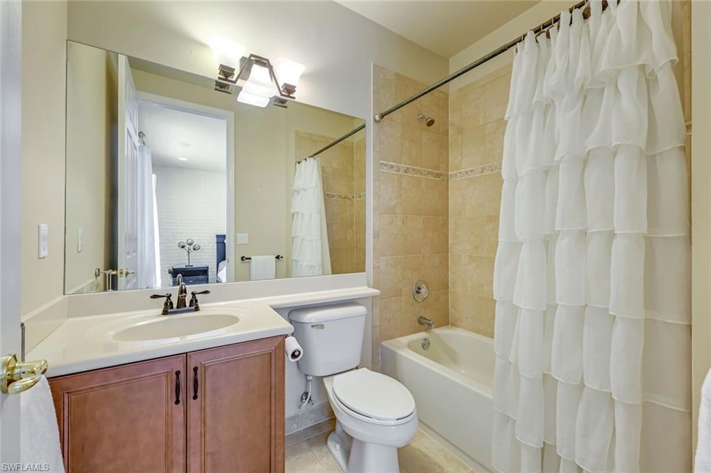6582 Monterey Point Naples, FL 34105 - Photo 24 of 28 a bathroom with a sink vanity mirror and toilet