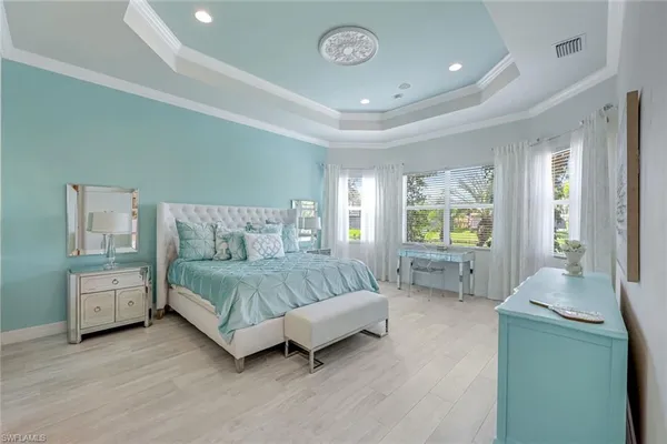 a spacious bedroom with a bed and window