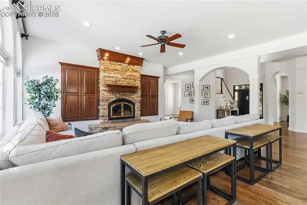 a living room with furniture fireplace and a large window