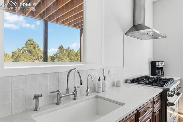 a kitchen with granite countertop a stove top oven a sink and dishwasher