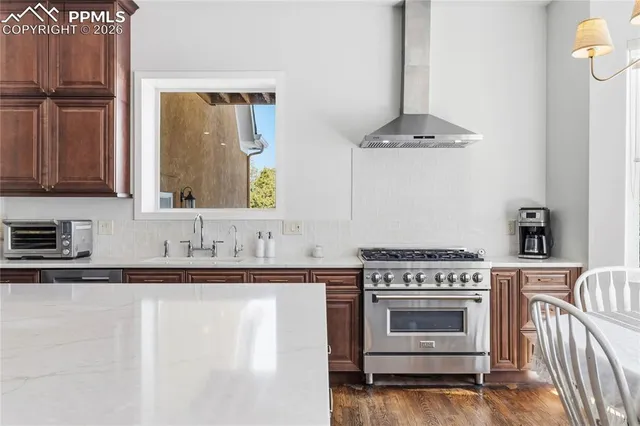 a kitchen with a table chairs refrigerator and microwave