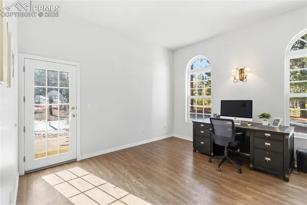 a view of a workspace with furniture and a window