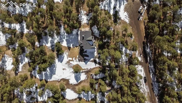 a aerial view of a house with table and chairs